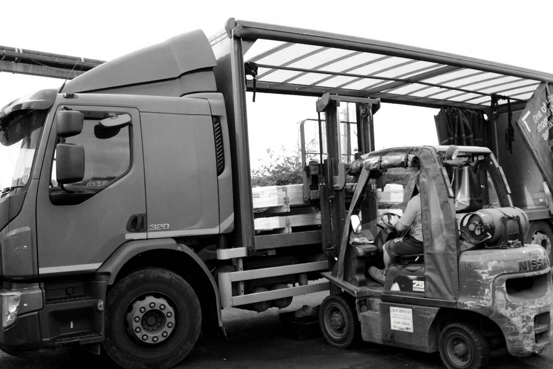 delivery truck being loaded by forklift
